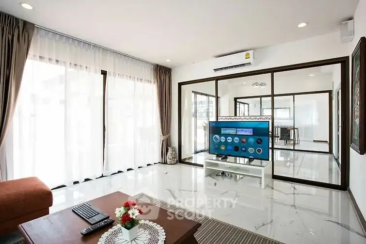 Spacious modern living room with large windows and elegant decor