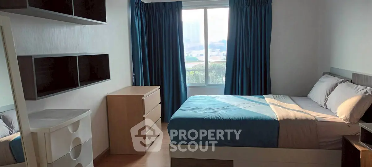 Cozy bedroom with natural light and modern furnishings, perfect for relaxation.