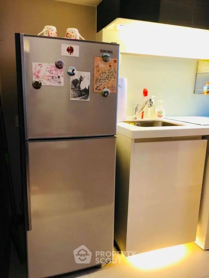 Modern kitchen with stainless steel fridge and sleek cabinetry