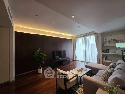 Elegant living room with modern decor, large windows, and cozy seating area.