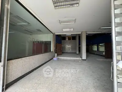 Spacious commercial space with large windows and open layout, ideal for retail or office use.