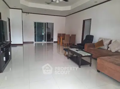 Spacious living room with modern furniture and sleek tile flooring
