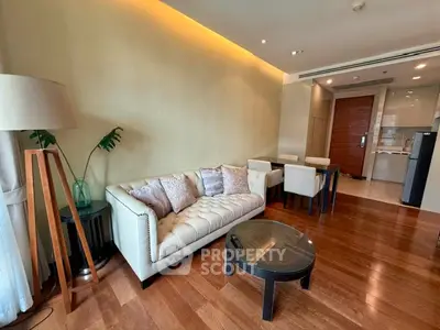 Modern living room with elegant sofa and dining area in open layout apartment.