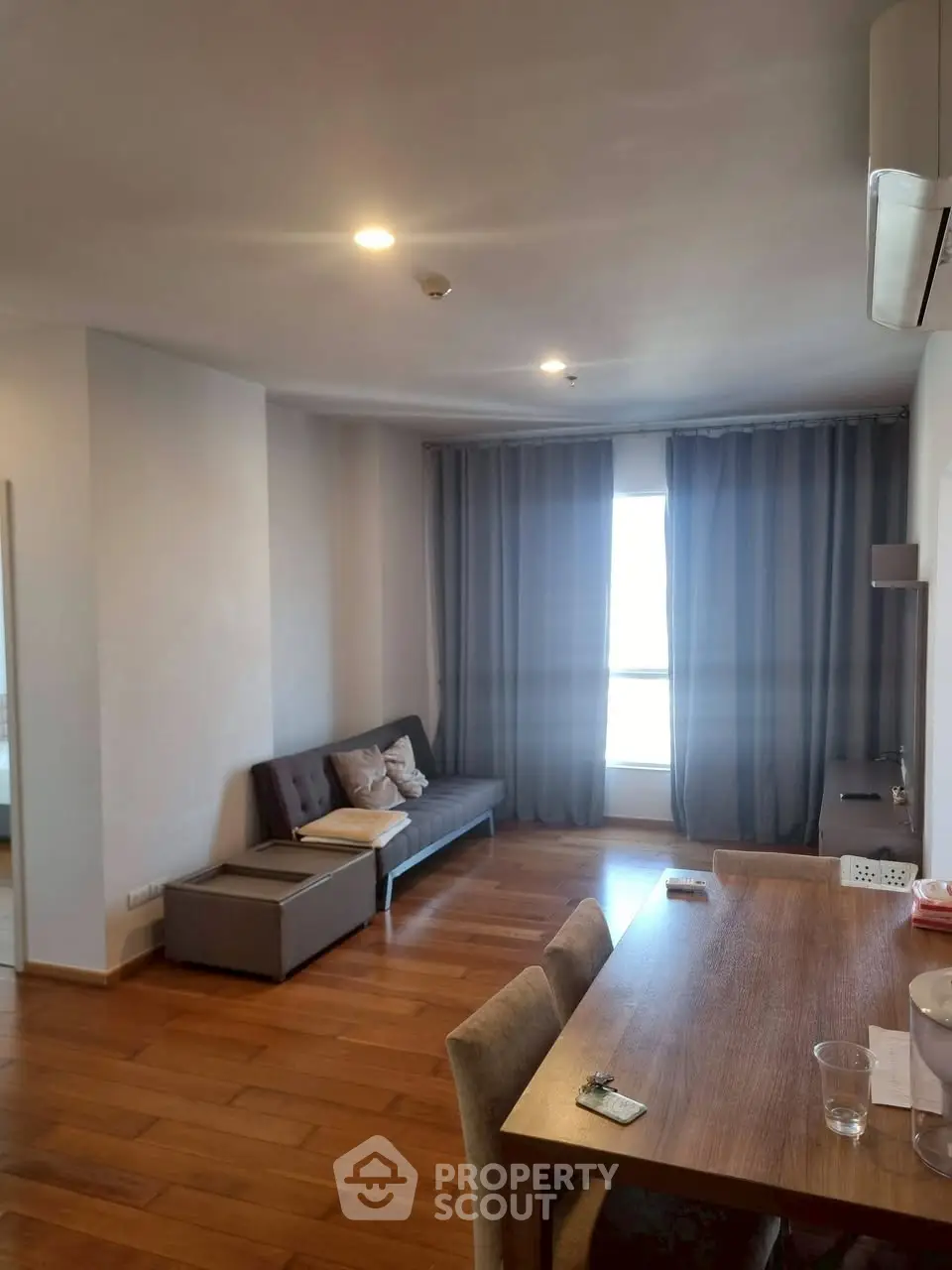 Spacious living room with wooden flooring and modern furniture