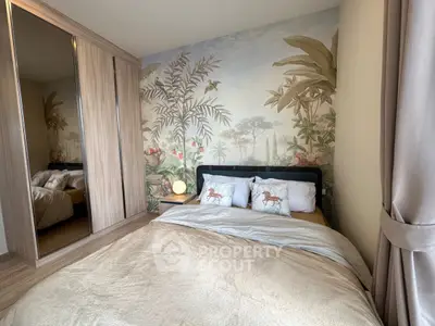 Charming bedroom with tropical-themed wallpaper and mirrored wardrobe