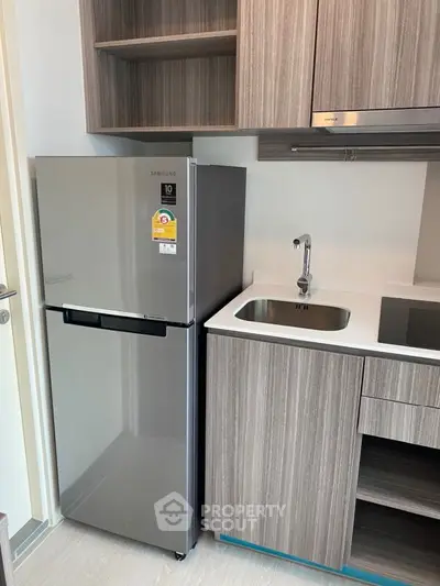 Modern kitchen with sleek stainless steel appliances and contemporary design.