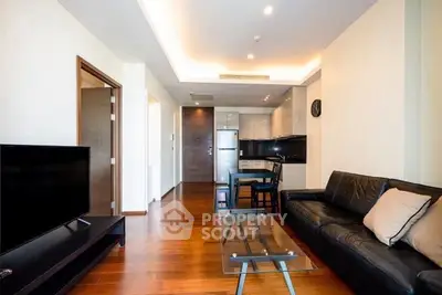 Modern living room with sleek furniture and open kitchen layout