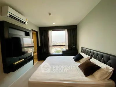 Modern bedroom with city view, featuring a sleek design and comfortable furnishings.