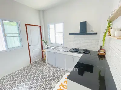 Modern kitchen with gas stove and stylish tile flooring