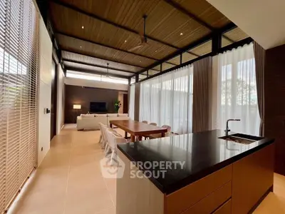 Luxurious open-plan living room with modern kitchen and elegant dining area