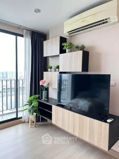 Modern living room with sleek TV unit and balcony view