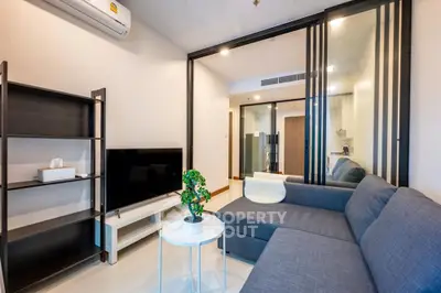 Modern living room with sleek furniture and stylish decor in a contemporary apartment.