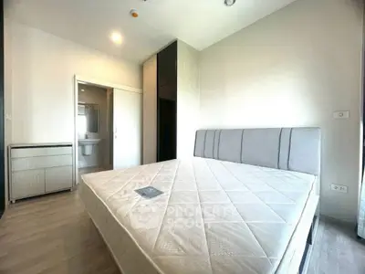 Modern bedroom with minimalist design and ample natural light.