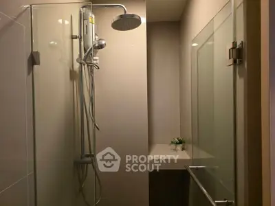 Modern bathroom with glass shower enclosure and sleek fixtures