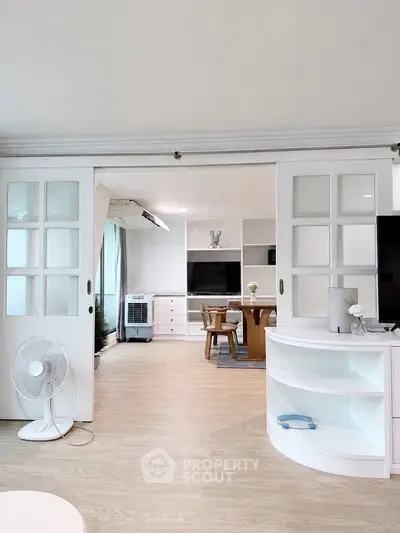 Spacious living room with sliding doors and modern decor in a bright apartment