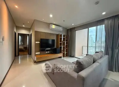 Modern living room with city view and cozy gray sofa