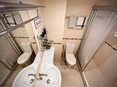 Modern bathroom with sleek fixtures and glass shower enclosure