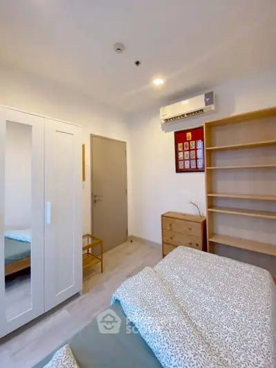 Cozy bedroom with modern furnishings and air conditioning in a bright apartment.