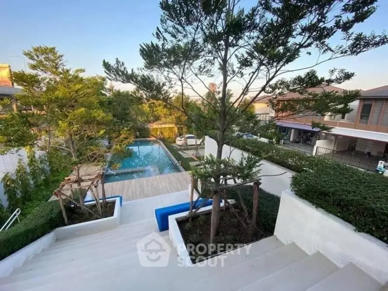 Luxurious residential pool area with lush greenery and modern design