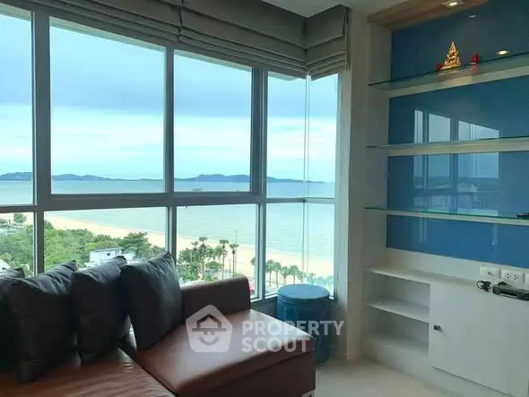 Stunning beachfront living room with panoramic ocean views and modern decor.