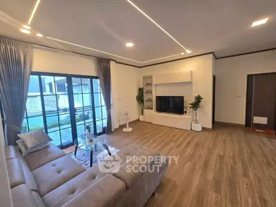 Spacious modern living room with large windows and stylish decor