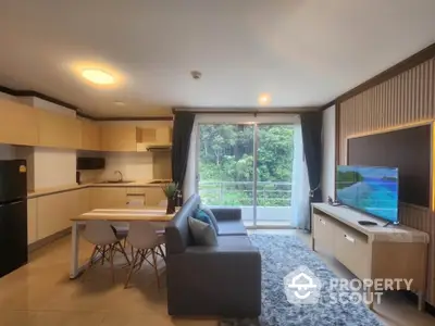 Modern open-layout living room with kitchen and balcony view