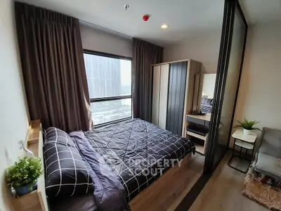 Modern bedroom with large window and stylish decor in urban apartment