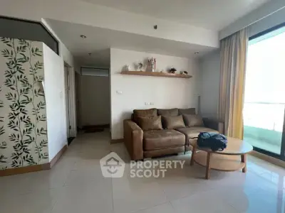 Spacious living room with modern decor and large window for natural light.