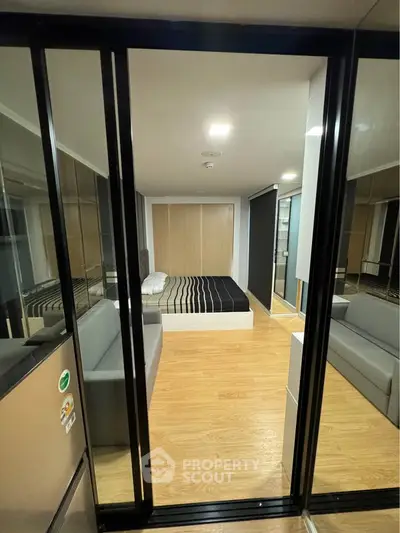 Modern studio apartment with sleek design and glass partition