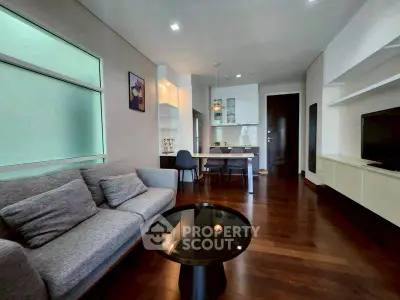 Modern living room with sleek furniture and open layout, featuring hardwood floors and stylish decor.