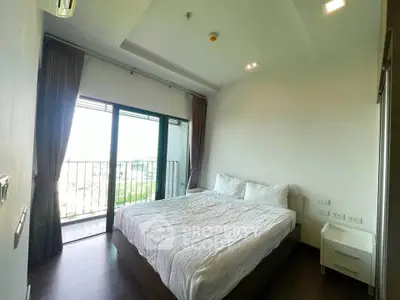 Spacious bedroom with balcony and natural light in modern apartment