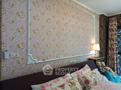 Charming bedroom with floral wallpaper and cozy decor