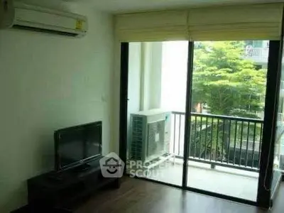Modern living room with balcony view and air conditioning unit, perfect for urban living.