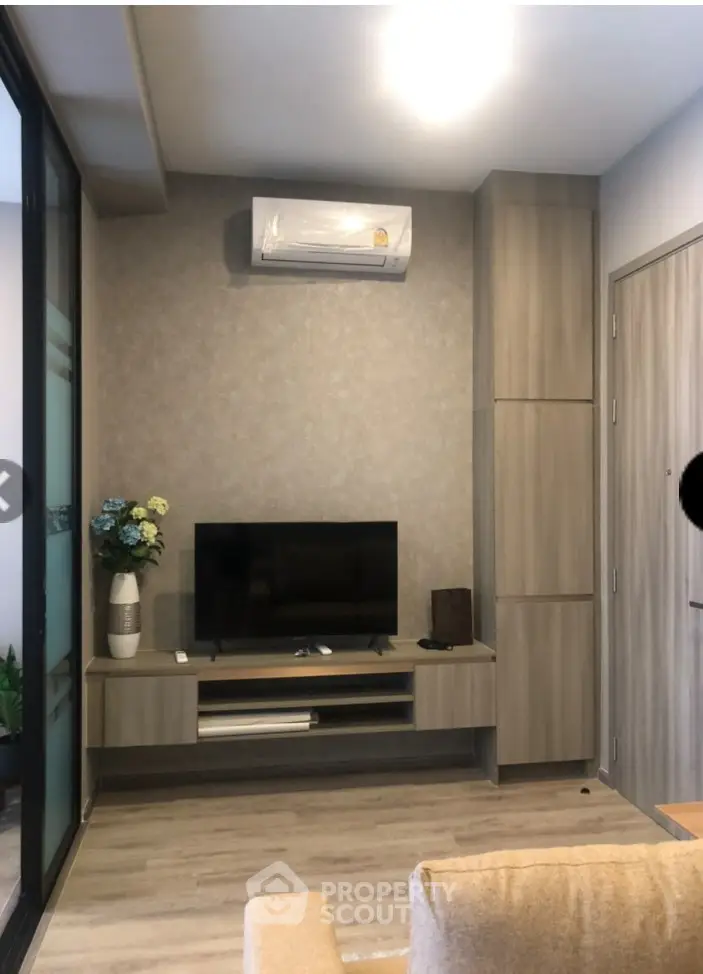 Modern living room with sleek TV stand and air conditioning unit