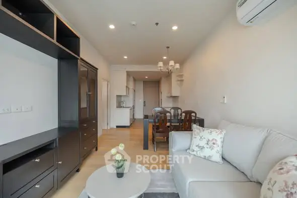 Spacious modern living room with elegant furniture and open kitchen layout