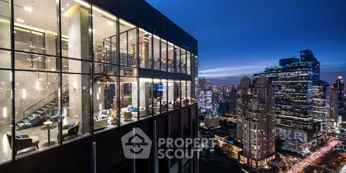 Luxurious high-rise building with stunning cityscape view at dusk, featuring floor-to-ceiling windows and modern design.