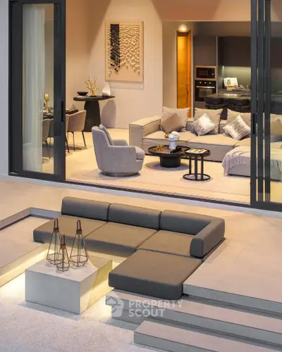 Luxurious modern living room with open layout and stylish outdoor seating area.