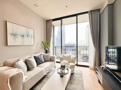 Luxurious living room with modern decor and city view balcony in high-rise apartment.