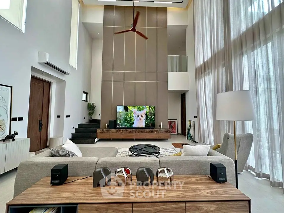 Luxurious modern living room with high ceilings and elegant decor