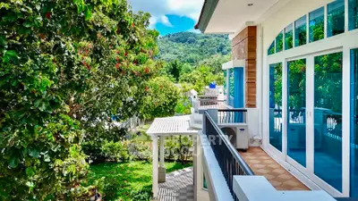 Stunning balcony view of lush greenery and modern architecture in a serene setting.