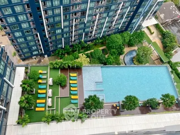 Luxurious high-rise apartment with stunning pool and lush garden view.
