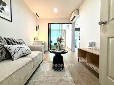 Modern living room with stylish decor and open layout, featuring cozy seating and elegant lighting.