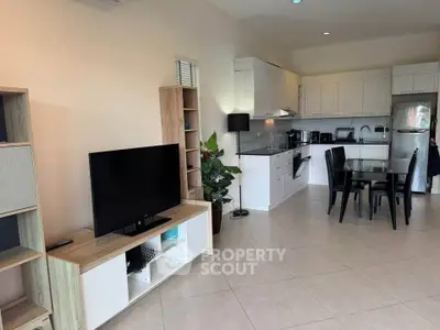 Spacious open-plan living room and kitchen with modern appliances and stylish decor.
