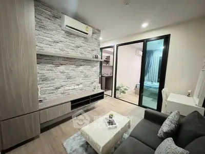 Modern living room with stylish stone accent wall and cozy furnishings