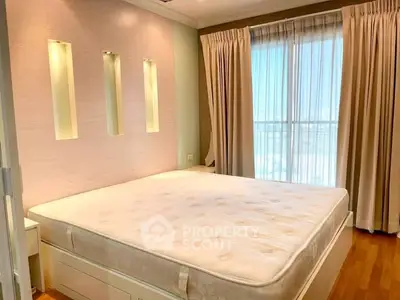 Spacious bedroom with large windows and elegant curtains, featuring a comfortable bed and modern design.