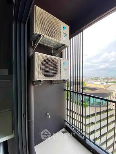 Modern balcony with air conditioning units and city view, perfect for urban living.