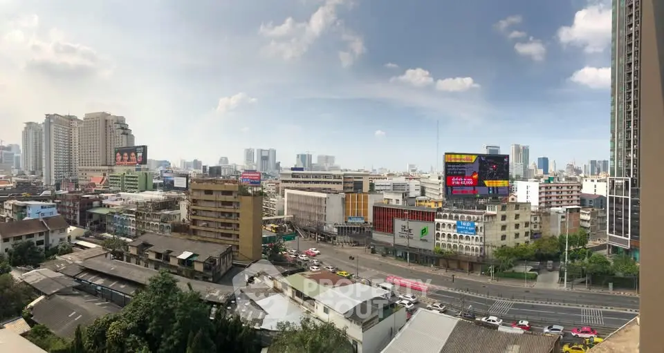Panoramic cityscape view showcasing urban skyline and bustling streets.