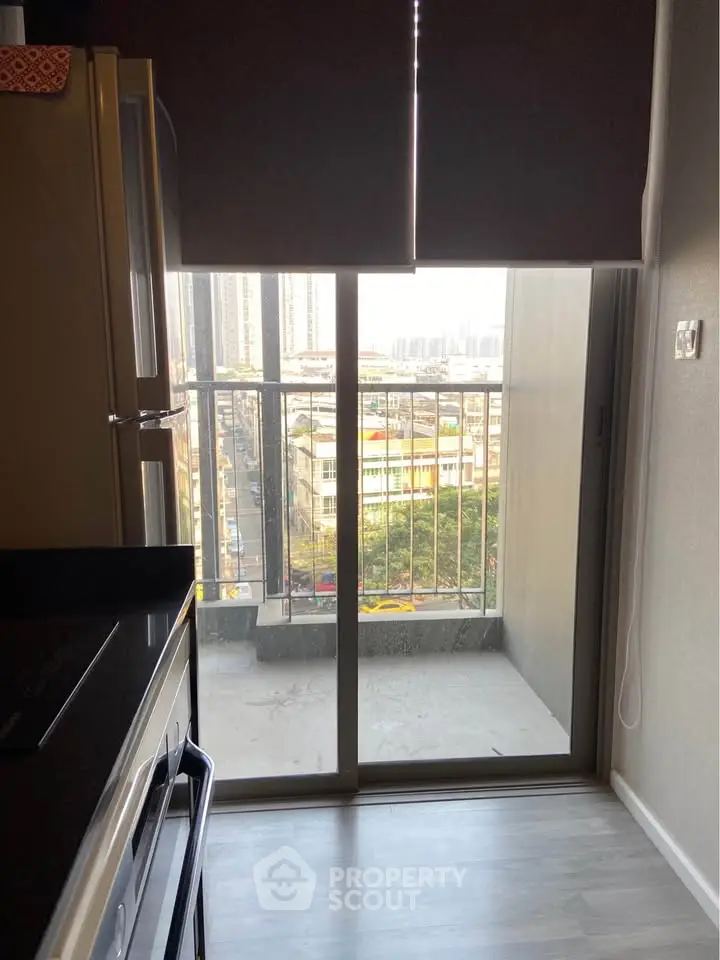 Modern kitchen with balcony view in urban apartment
