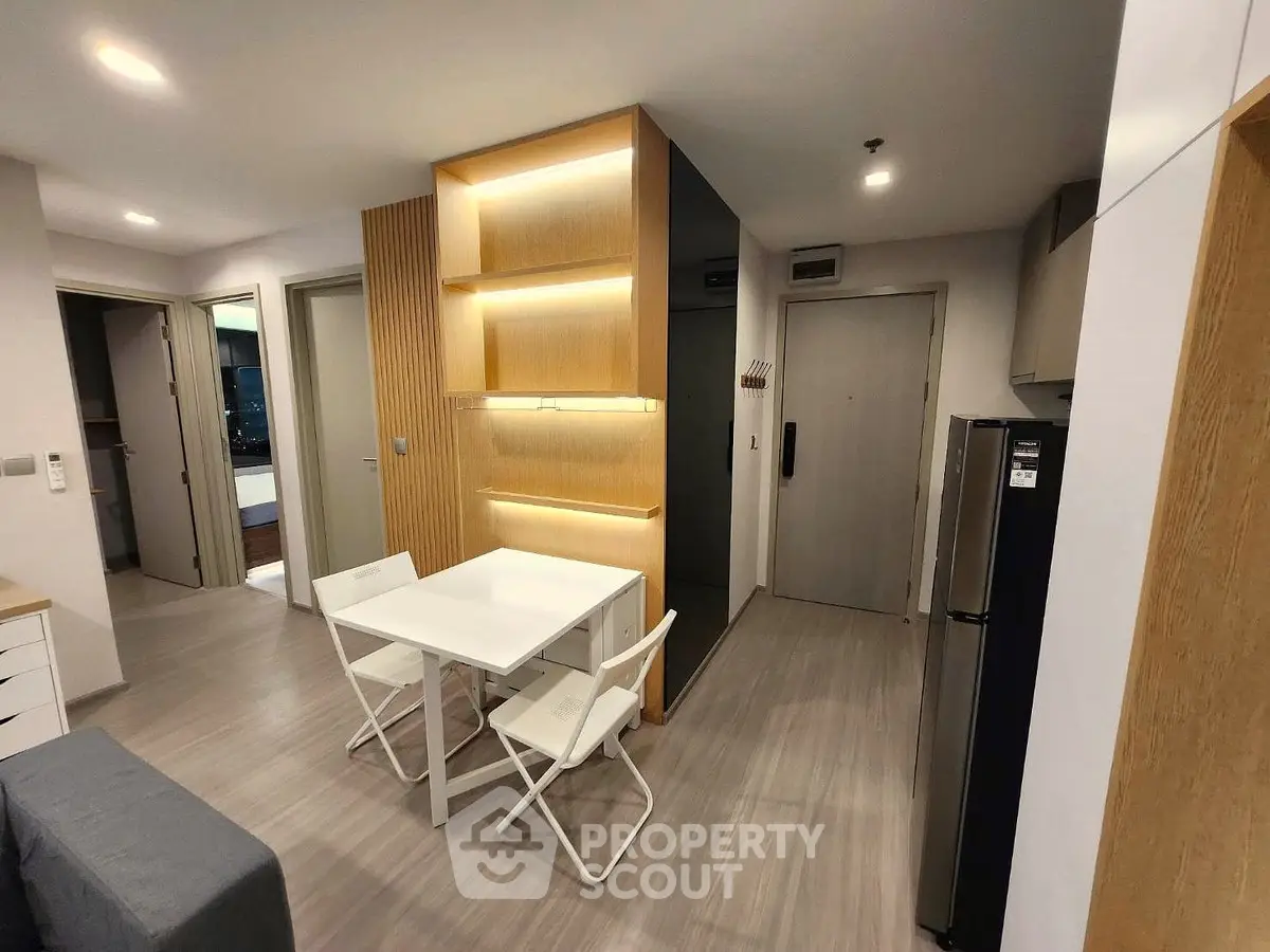 Modern apartment interior with dining area and sleek kitchen design