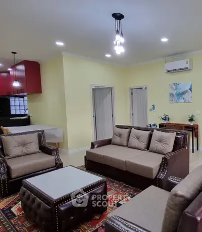 Spacious living room with elegant furniture and open kitchen layout, perfect for modern living.
